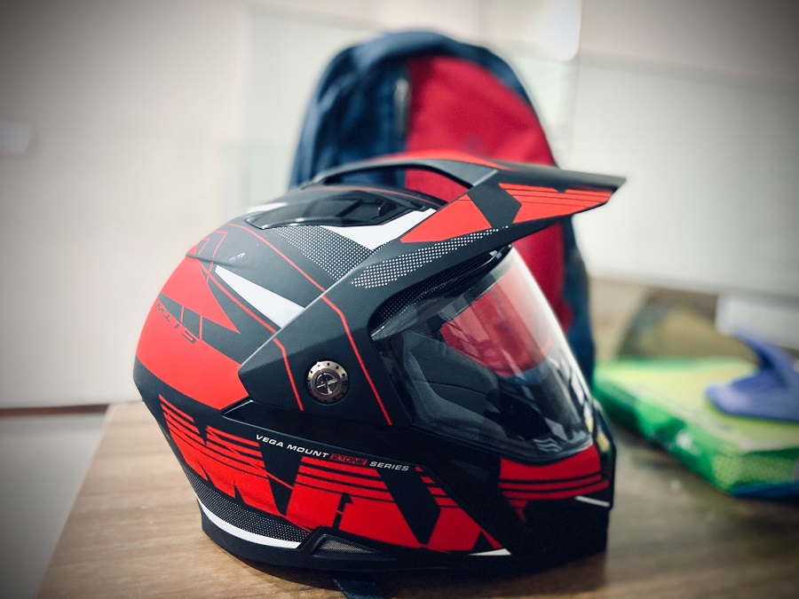 black and red snowmobile helmet